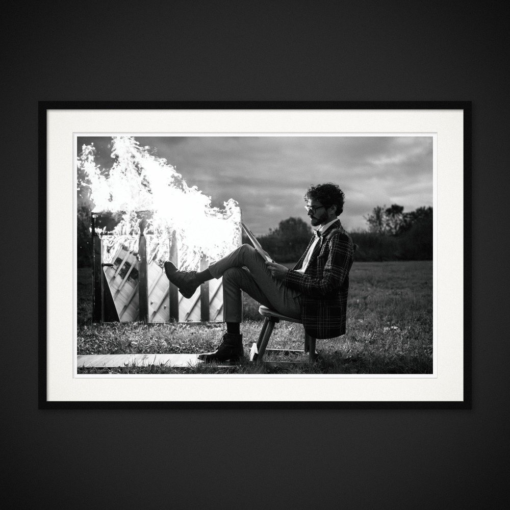 Fahrenheit 440 — A seated figure rests a foot against a burning piano. Framing preview by Albert Pocej; frame not included.