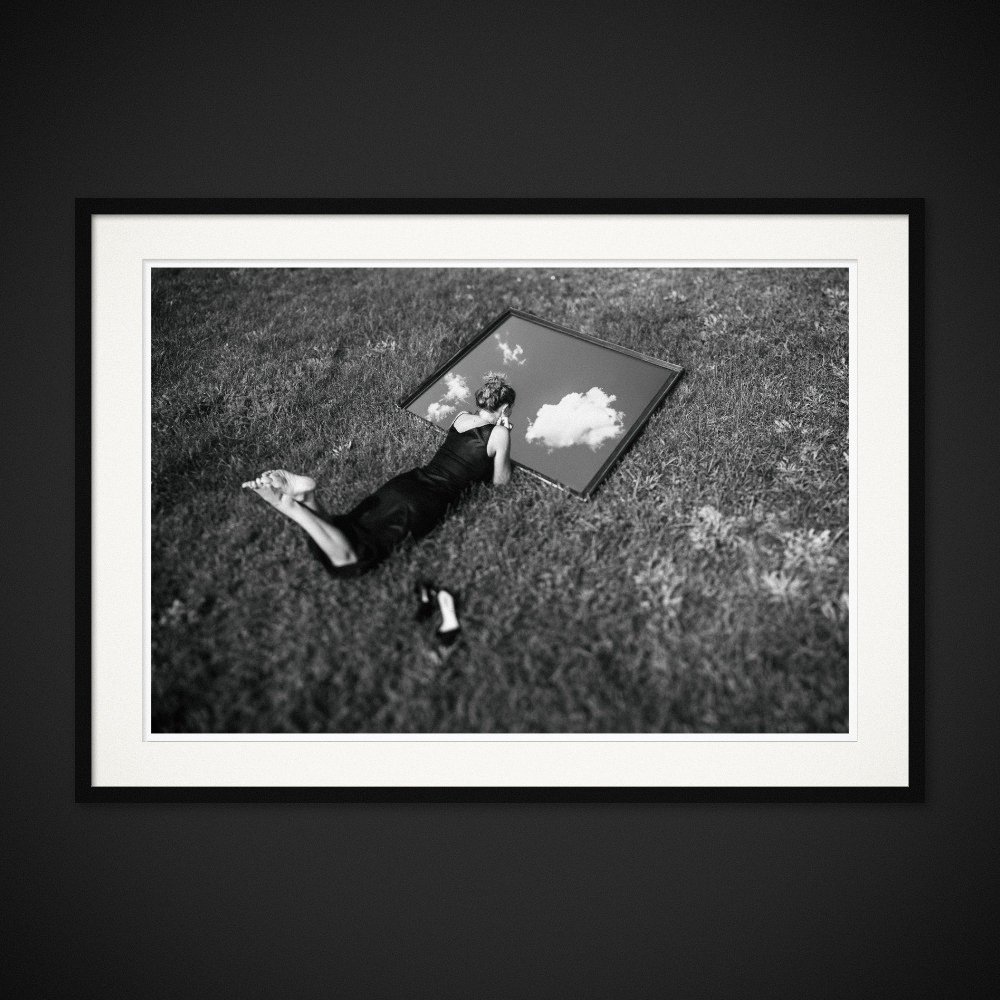 Internal Horizons — A mirror brings the sky down beside a figure lying in the grass. Framing preview by Albert Pocej; frame not included.