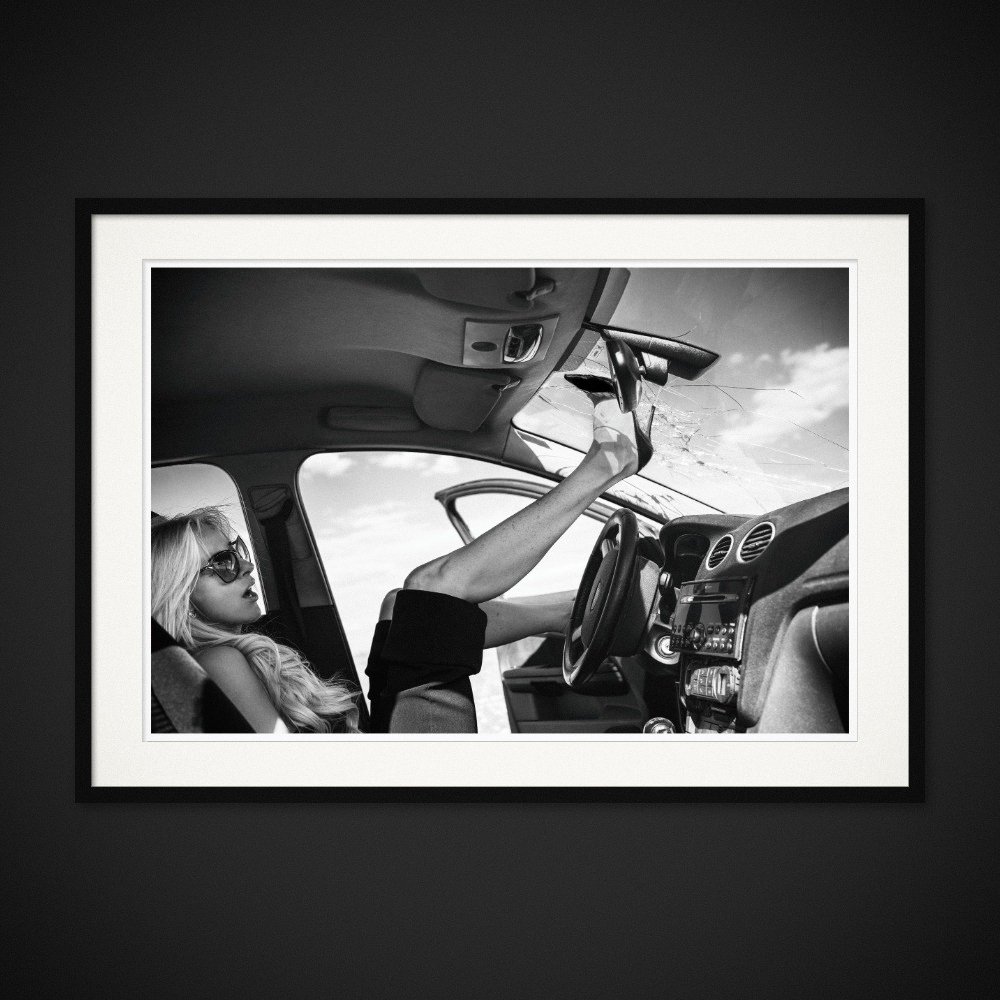 Louboutin Revenge — A high heel reaches the roof of a car from the passenger seat. Framing preview by Albert Pocej; frame not included.