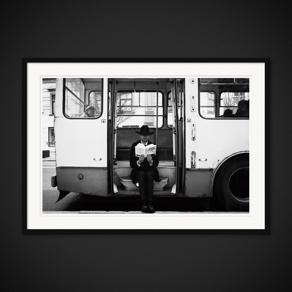 Ticket To Read — A reader pauses in the open doorway of a bus. Framing preview by Albert Pocej; frame not included.